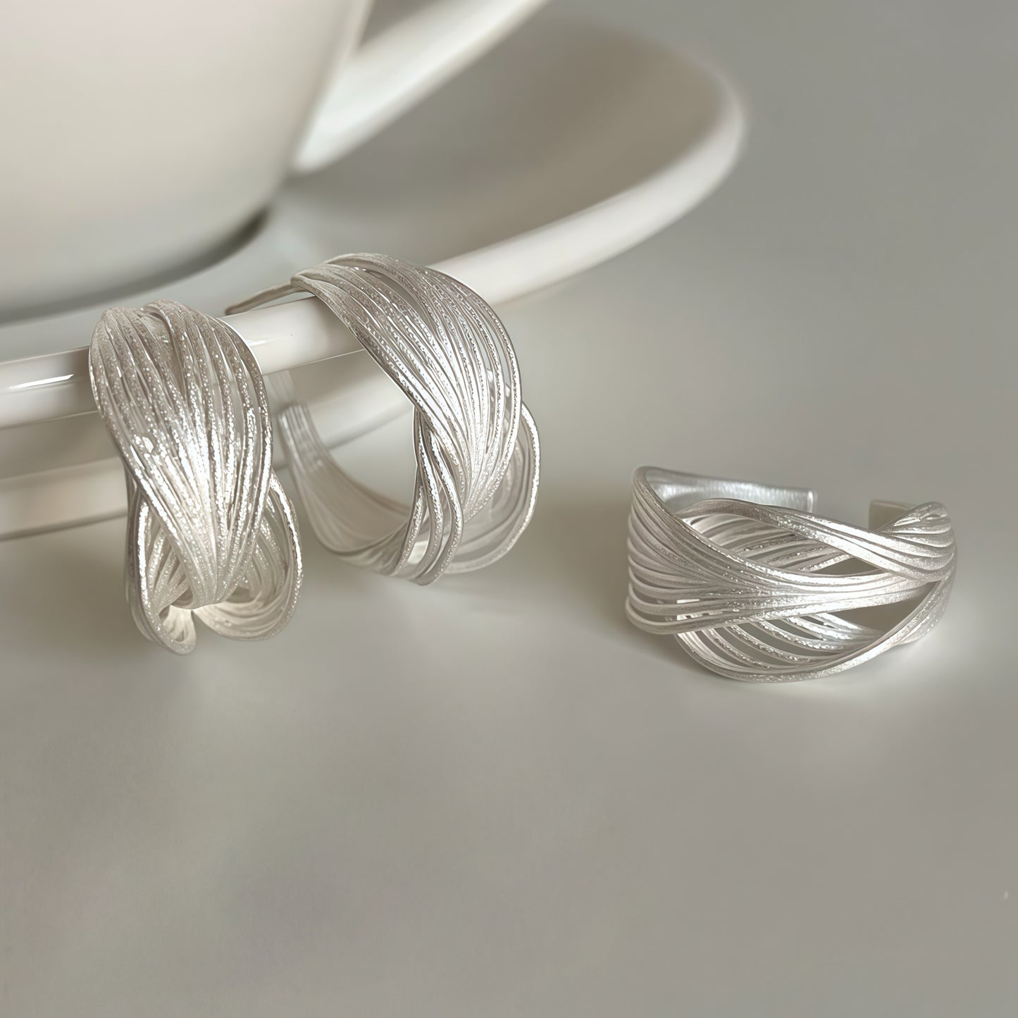 Interwoven Silver Hoop Earrings – Sculptural Modern Design
